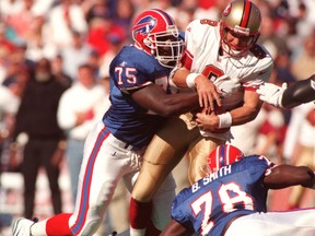 Buffalo Bills defensive end Marcellus Wiley sacks San Francisco 49ers quarterback Steve Young early in the third quarter of a 2009 NFL game. (Reuters)