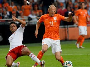Arjen Robben of the Netherlands fights for the ball with Neil Taylor of Wales during their international friendly soccer match in Amsterdam June 4, 2014. (REUTERS/Toussaint Kluiters/United Photos)