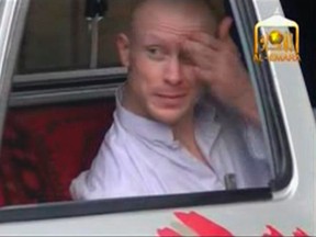 U.S. Army Sergeant Bowe Bergdahl waits in a pick-up truck before he is freed at the Afghan border, in this still image from video released June 4, 2014. (REUTERS/Al-Emara via Reuters TV)