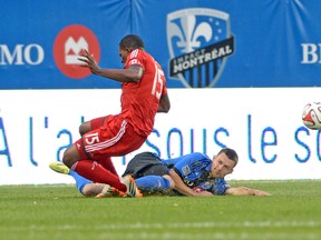 Montreal’s Jack McInerney takes down TFC’s Doniel Henry during Tuesday night’s game. (SEBASTIEN ST-JEAN/QMI AGENCY)