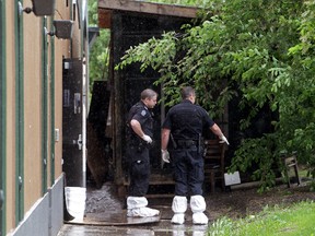 Police investigate after a body was discovered behind MacTaggert's, 17328 Stony Plain Road, in Edmonton Alta., on Wednesday June 4, 2014. David Bloom/Edmonton Sun/QMI Agency