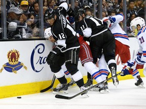 New York Rangers defenceman Anton Stralman is pinned to the boards by Los Angeles Kings right wing Marian Gaborik as Rangers centre Derek Stepan during Game 1 of the Stanley Cup final at the Staples Center in Los Angeles, June 4, 2014. (KIRBY LEE/USA Today)