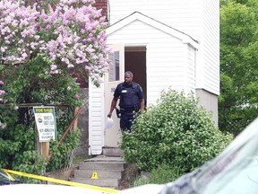 Gino Donato/Sudbury Star file photo   
A Greater Sudbury Police Services officer leaves the Donovan house where the suspect in a fatal stabbing resided. The 17-year-old female was charged with second-degree murder.