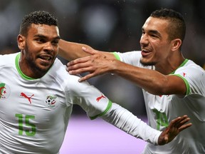 Algeria's forward Hilal Soudani (L) celebrates with teammate midfielder Nabil Bentaleb after he scored his team's second goal during the friendly football match between Algeria and Romania on June 4, 2014, at the Geneva Stadium in Geneva, ahead of the upcoming 2014 FIFA World Cup in Brazil.  (AFP PHOTO / FABRICE COFFRINI)