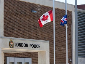 London police lowed flags to half mast on Thursday to honour the three RCMP officers killed in Moncton. DEREK RUTTAN / THE LONDON FREE PRESS