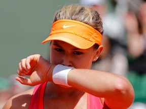 Eugenie Bouchard of Canada wipes her face during her women's semifinal match against Maria Sharapova of Russia at the French Open tennis tournament at the Roland Garros stadium in Paris June 5, 2014. (REUTERS/Jean-Paul Pelissier)