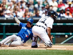 Toronto Blue Jays second baseman Brett Lawrie (left) slides into home safely ahead of the throw to Detroit Tigers catcher Alex Avila in the fourth inning Thursday at Comerica Park. (Rick Osentoski/USA TODAY Sports)