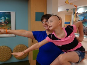 Bridget Zavitske, who's being treated for cancer at CHEO, poses with her mom, Christy, at the hospital. Bridget posing as Super Girl Bridget Rose in her fight against evil Captain Cancer. 
(MEGAN GILLIS/OTTAWA SUN)