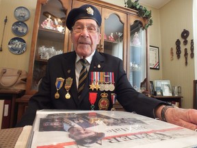 When Allied troops stormed the beaches of Normandy on D-Day 70 years ago, Bill Hale was driving a tank. Now 91, and decorated in army medals, Hale holds a scrapbook collection of his war memories. BRENT BOLES / THE OBSERVER / QMI AGENCY