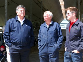 Liberal finance minister, Charles Sousa, left, received an education in agriculture along with Libearl candidate colleague Daniel Moulton, right, while touring Herman Olthaar's dairy operation near Salford Thursday morning. 
TARA BOWIE / SENTINEL-REVIEW / QMI AGENCY