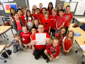Elementary school teacher Chris Constantine holds a letter his class wrote to newspapers across Canada and England as part of their D-Day learning at Clara Brenton Public School in London. The 27 pupils also wrote letters to veterans, watched video footage, and wrote journal entries from a soldier's perspective.
CRAIG GLOVER/The London Free Press/QMI Agency