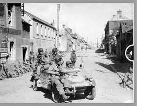 U.S. Army paratroopers of the 101st Airborne Division drive a captured German Kubelwagen on D-Day at the junction of Rue Holgate and RN13 in Carentan, France, June 6, 1944 (L). Girls run across the street at the same intersection, June 21, 2013 (R).

REUTERS/US National Archives/Handout via Reuters (L) Chris Helgren (R)