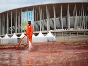 A worker cleans outside the Mane Garrincha National Stadium ahead of the 2014 World Cup, in Brasilia June 5, 2014. (REUTERS/Ueslei Marcelino)