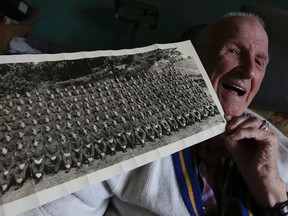 Myer Goobie, 93, shows a photo of his company in the Second World War  in his East York home on June 5, 2014. (Dave Thomas/Toronto Sun)