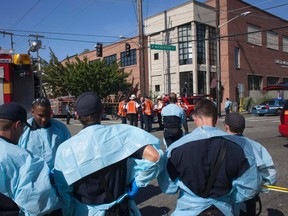 Aid workers standby at Seattle Pacific University after the campus was evacuated due to a shooting in Seattle, Washington June 5, 2014. (REUTERS/David Ryder)