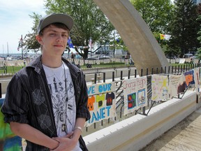 Harley Brushey, a Grade 12 student from Queen Elizabeth Collegiate Vocational Institute, created the Climate Action Clothesline banner for the Clean Air Day art installation at Confederation Park. Julia McKay/The Whig-Standard