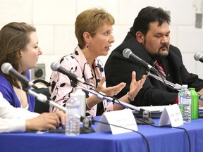 Gino Donato/The Sudbury Star
Incumbent France Gelinas makes a point as PC candidate Marck Blay, Green candidate Heather K. Dahlstrom and Liberal James Tregonning look on,  during the Greater Sudbury Chamber of Commerce Nickel Belt all candidates event at Confederation Secondary School on Thursday night.