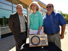 Architect Randy Wilson, Jane McKelvie, chair of the UTRCA’s board of directors, and George Marr, chair of the UTRCA’s building committee, stand next to a plaque recognizing the LEED platinum status of the Watershed Conservation Centre in London, Ont. June 5, 2014. CHRIS MONTANINI\LONDONER\QMI AGENCY