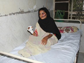 Saba Maqsood, 18, sits on a hospital bed in Hafizabad in Punjab province on June 6, 2014. Maqsood has survived being shot and thrown in a canal by her family for marrying the man she loved, police said, weeks after the "honour killing" of another woman drew worldwide condemnation. (REUTERS/Yaqoob Shahzad)