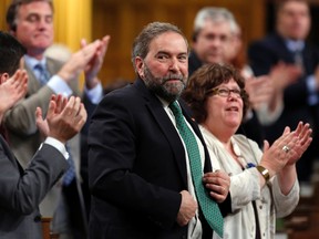 New Democratic Party leader Thomas Mulcair (C) receives a standing ovation from his caucus during Question Period in the House of Commons on Parliament Hill in Ottawa June 3, 2014. (REUTERS/Chris Wattie)