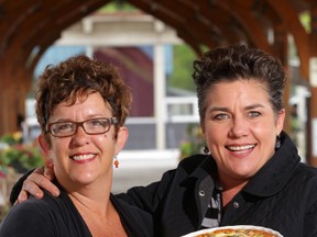Brenda Foran, left, and Sam McGowan hold tarts and a quiche at the Belleville Farmers' Market in Belleville, Ont. Thursday, June 5, 2014. Their catering business, 2 Girls and an Oven, joined the market about three weeks ago. - Luke Hendry/The Intelligencer/QMI Agency