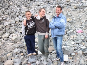 A family of chrome pickers take a break from work in Bulqiza, Albania. Children in the country work the side of the mountains, outside mining areas, looking for scraps to sell through an intricate black market. (photo by Thane Burnett, special to QMI Agency)