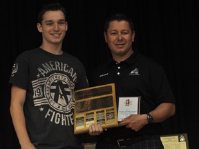 Michael Lavallee is presented the Barry Sharpe Award for PCI senior male athlete of the year plus a $400 bursary from Keystone Sports by phys-ed teacher Cam Asham.  (Kevin Hirschfield/THE GRAPHIC)