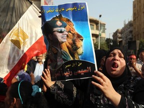A woman holds up a Sisi poster in front of a polling station during the presidential elections in Cairo May 26, 2014. (REUTERS)