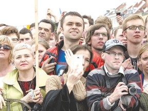 People listen to speeches in the Royal Square in Warsaw, Poland, on Wednesday during the Freedom Day event honouring the 25th anniversary of the first partly-free parliamentary elections in the Soviet Bloc. The breakthrough in Poland led to the collapse of communism in eastern Europe. (Fred Dufour/AFP Photo)