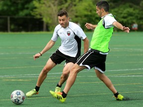 Ottawa Fury FC midfielder Sinisa Ubiparipovic, left, battles defender Mauro Eustquio for the ball at training at Carleton University Friday. Ubiparipovic injured his hamstring later in practice and has been ruled out for Sunday's match in New York. (Chris Hofley/Ottawa Sun)