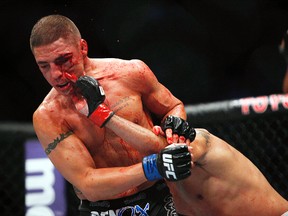 Diego Sanchez (left) fights Gilbert Melendez in their lightweight bout during UFC 166 at the Toyota Center in Houston, Oct. 19, 2013. (ANDREW RICHARDSON/USA Today)