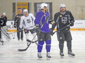 Los Angeles Kings right wing Justin Williams (purple) talks with defenceman Drew Doughty during practice yesterday. (USA TODAY SPORTS)