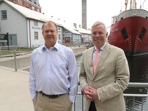 Marine museum manager Doug Cowie, left, and board of trustees chairman Chris West in front of the museum and the Alexander Henry.  (Michael Lea/The Whig-Standard)