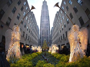The Christmas tree in Rockefeller Center is lit up on Christmas Day in New York, December 25, 2013. (REUTERS/Carlo Allegri)