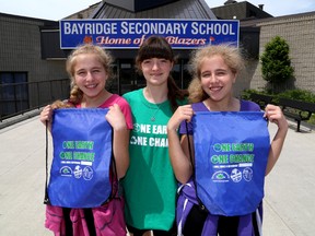 Bayridge Secondary School students and active volunteers, from left, Tiffanie Bankosky, Alyssa Burrows and Tia Bankosky stand outside of their school. (Ian MacAlpine/The Whig-Standard)