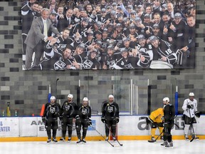 Los Angeles Kings players stand under a banner from their 2012 championship season during practice on Friday. (USA TODAY SPORTS)