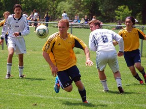 St. Joseph's Catholic High School player Ryan Pocrnic, second from left, charges toward the goat in the WOSSAA 'AA' soccer gold medal game against St. Michael's. (Ben Forrest, Times-Journal)