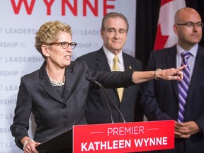 Ont. Premier Kathleen Wynne, left, and Toronto Deputy Mayor Norm Kelly, middle, during a press conference after they both spoke at the Canadian Club of Toronto at the Metro Toronto Convention Centre in Toronto, Ont. on June 5, 2014. (Ernest Doroszuk/QMI Agency)