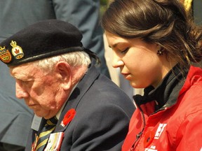 Photo by Lance Holdforth
Canadian veteran Henry Greenwood, 90, sits next to Briana Bedard-Paquette, 16, from Confederation Secondary School during a prayer at a ceremony in Beny-sur-Mer Cemetery, seven kilometres east of Juno Beach on Thursday. Both Greenwood and Bedard-Paquette attended the 70th anniversary of D-Day ceremony at the Juno Beach Centre in Nomandy, France.