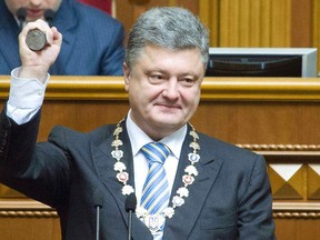 Ukraine's President-elect Petro Poroshenko shows the presidential seal during his inauguration ceremony in the parliament hall in Kiev June 7, 2014.  Poroshenko took the oath on Saturday as Ukraine's president, buoyed by Western support but facing an immediate crisis in relations with Russia as a separatist uprising seethes in the east of his country.  REUTERS/Anastasia Sirotkina/Pool