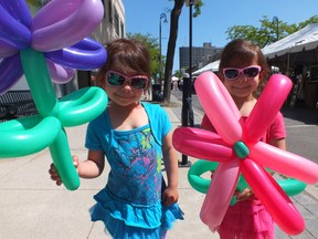 Lily, left, and her twin sister Victoria show off their inflatable baloon flowers they got at Artwalk. BRENT BOLES / THE SARNIA OBSERVER