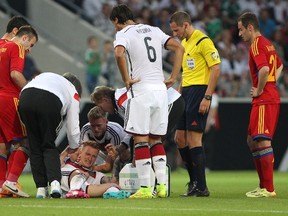 Germany's midfielder Marco Reus reacts injured on the pitch during the friendly football match Germany vs Armenia in preparation for the FIFA World Cup 2014 on June 6, 2014 in Mainz, central Germany. (AFP PHOTO/DANIEL ROLAND)