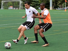 Saturday, June 7, 2014 Ottawa --  Ottawa Fury FC midfielder Tony Donatelli, left, fights for possession against forward Pierre-Rudolph Mayard at at training at Carleton University Friday., June 6, 2014 (Chris Hofley/Ottawa Sun/QMI AGENCY)