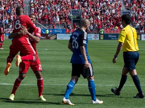 Reds forward Jermain Defoe celebrates his goal with teammate Luke Moore during Saturday's game against the San Jose Earthquakes  at BMO field. (Nick Turchiaro-USA TODAY Sports)