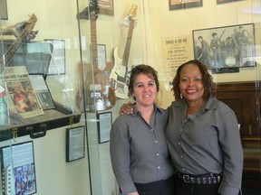 Assistant manager Bonnie Brandt (left) and manager Jennifer Platt pose in front of the collection of rock 'n' roll memoribilia at the Pembina and Stafford Salisbury House location. (GLEN DAWKINS/Winnipeg Sun)