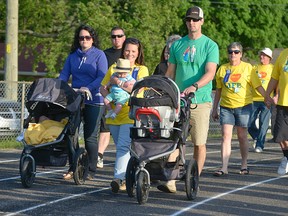 Guest speaker and torch bearer Jenny (Aspden) Botzang leads the Survivor Lap Friday night at the Tillsonburg Relay for Life. CHRIS ABBOTT/TILLSONBURG NEWS