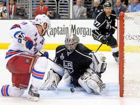 Kings goalie Jonathan Quick, stopping Brad Richards in close on Saturday night, has not been as dominant as he was two seasons ago when he won the Conn Smythe Trophy. (AFP)