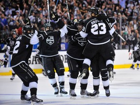 Los Angeles Kings right wing Dustin Brown (23) celebrates with his teammates after scoring the game-winning goal against the New York Rangers in the second overtime period during game two of the 2014 Stanley Cup Final at Staples Center on Jun 7, 2014 in Los Angeles, CA, USA. (Gary A. Vasquez-USA TODAY Sports)