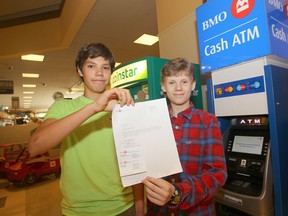 Caleb Turon (left) and Matthew Hewlett hacked a Bank of Montreal ATM and then alerted bank staff to the vulnerability of the ATM.  The 14 year olds were late returning to school from lunch, but had a note from the bank indicating they were helping with security. (Chris Procaylo/Winnipeg Sun/QMI Agency)