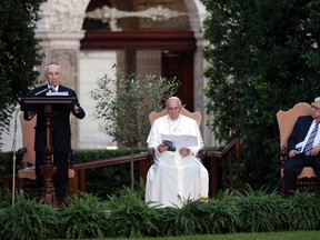 Israeli President Shimon Peres speaks as Pope Francis (C) and Palestinian President Mahmoud Abbas (R) listen in the Vatican Gardens at the Vatican June 8, 2014. REUTERS/Max Rossi